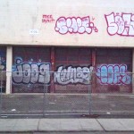 The chain-link fence surrounding the toxic site did little to deter local taggers. Every morning, the OUSD auto shop at 1032 4th Avenue seemed more colorful than it had been the night before. (Tagged for Demolition. Edward Cervantes, Oakland Voices, 2012)