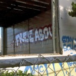 Sprayed on the shell of a toxic school site, the "stay in school" cliché is given an amusing twist. (Irony: Stay in School. Edward Cervantes, Oakland Voices 2012)