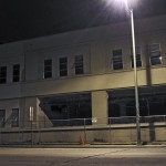 Regular police patrols along 10th Street deterred taggers on this side of the site, but even as I took this photo I could hear people fumbling in the unlit building salvaging what they could from the former high school. (Unlit Invitation. Edward Cervantes, Oakland Voices 2012.)