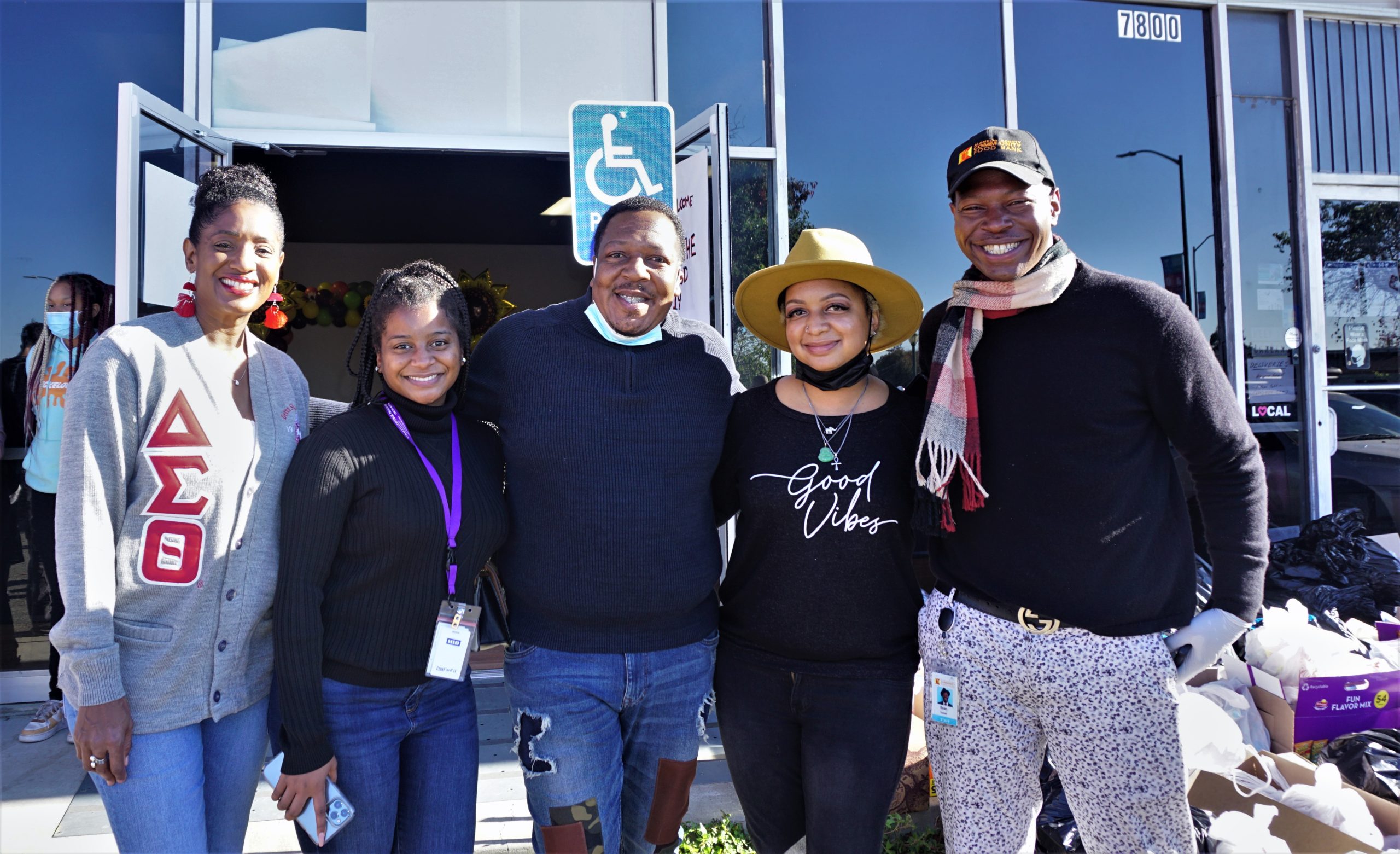 Five African Americans stand and smile for camera.