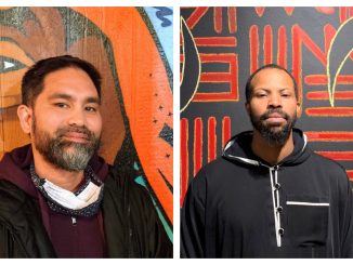 A Filipino American man with grey beard in front of orange mural; an African American man with beard and short hair in black hoodie in front of red and black mural