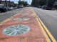 Street with orange bike lane with colorful wheels