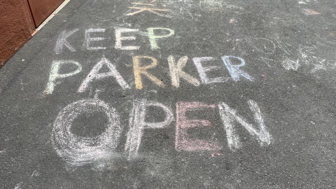 Chalk art that says "Keep Parker Open"