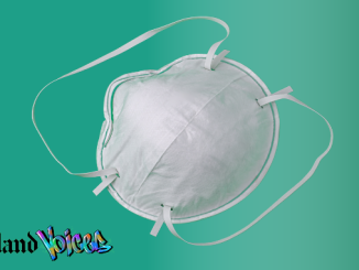 Photo of a white n95 grade face mask against a mint green background with the Oakland Voices logo in the lower left corner.