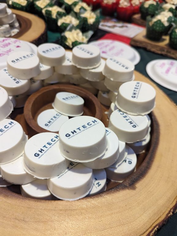 circular desserts covered with white icing and words that say GHTech