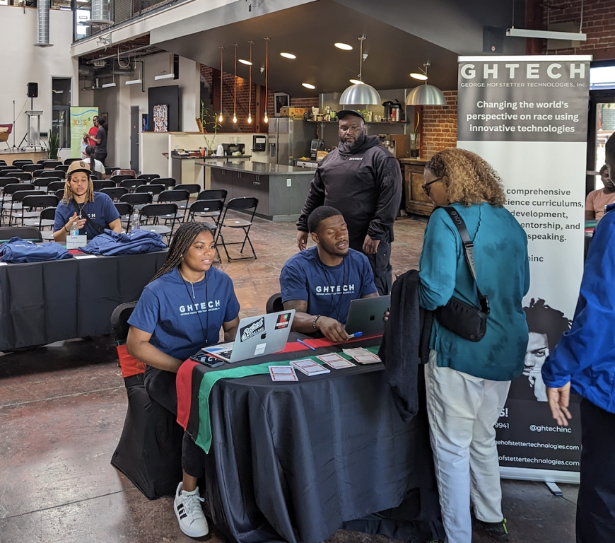 A table at a conference space where people are registering