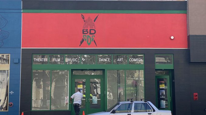 a window front with black, red, and green and words BAMBDCDC