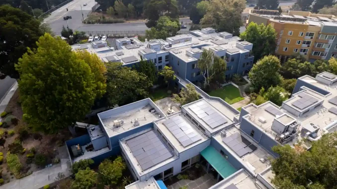 aerial view of a housing complex with solar rooftop panels
