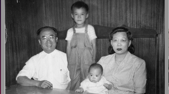 black and white photo of three Chinese American men eating inside a Chinese restaurant