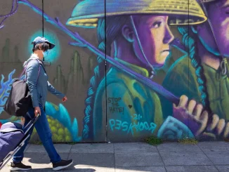 A person walks past a mural painted by Pancho Pescador in Oakland Chinatown on June 9, 2024. Credit: Amaya Edwards Posted in