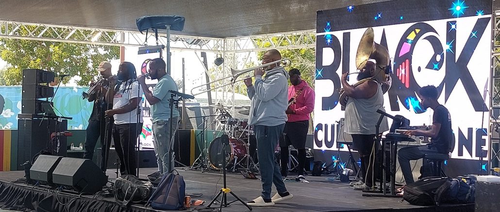 Image of a band playing on a stage.