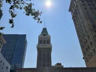 oakland tribune toward with sun above