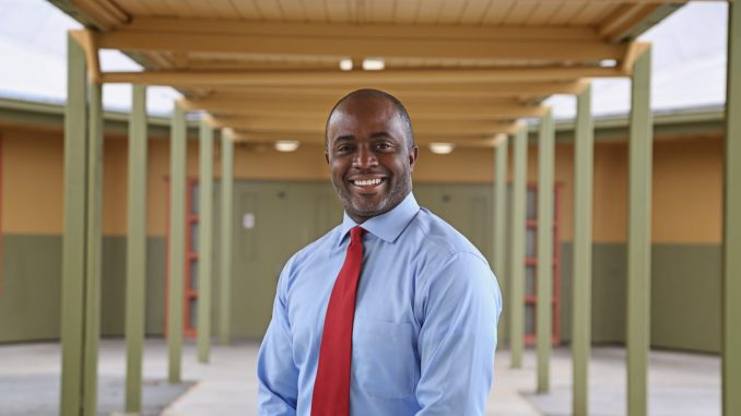 picture of smiling Black man wearing a shirt and tie