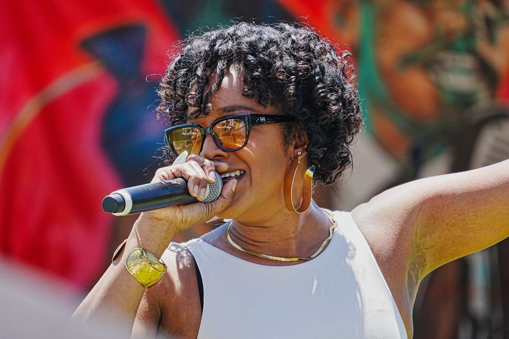 RyanNicole Austin performs with a microphone during the Malcolm X JazzArts Festival in Oakland.