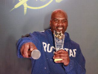 Black man holds trophy